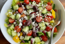 A vibrant, protein-packed Greek Chopped Salad bursting with fresh vegetables, olives, feta, and a light dressing, perfect for a healthy one-bowl meal.